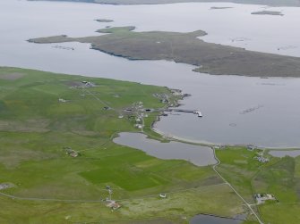 General oblique aerial view of Uyeasound with the island of Uyea beyond, looking SSW.