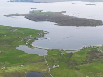 General oblique aerial view of Uyeasound with the island of Uyea beyond, looking SSW.