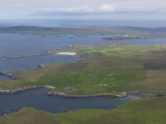 SGeneral oblique aerial view looking across Gloup, Breckton and Papil Ness on Yell, across the Bluemull Sound towards Wick on Unst in the distance, looking E.