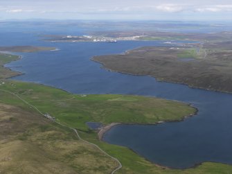 General oblique aerial view of Sullom Voe oil terminal in the distance with Haggrister in the foreground, looking NE.