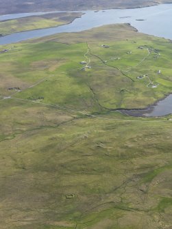 General oblique aerial view with Stanydale in the foreground and Gruting beyond, looking SSE.