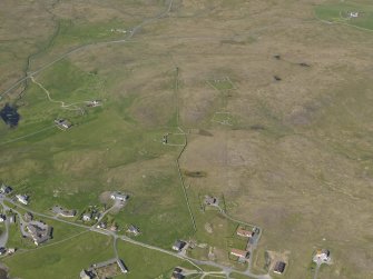 Oblique aerial view of the farmsteads and buildings, looking NE.