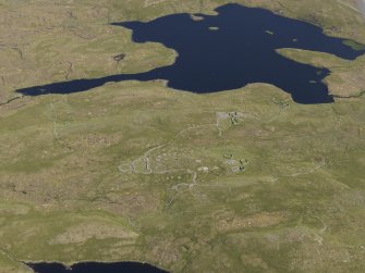 Oblique aerial view of the field systems, clearance cairns, cairns, buildings and other structures in the Loch of Flatpunds and Trolligarts area, looking SSE.