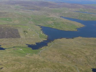 General oblique aerial view of brouster with West Houlland and Gruting Voe beyond, looking SE.