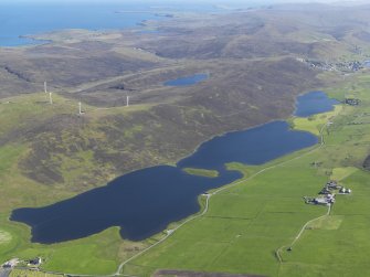 eneral oblique aerial view of the Loch of Tingwall with the Law Ting Holm in the foreground and Scalloway in the distance, looking S.