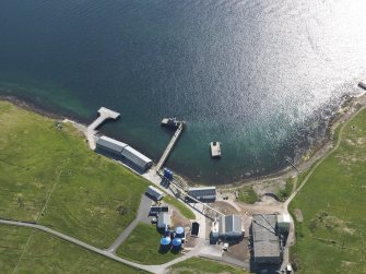 Oblique aerial view of the piers at Heogan, looking SW.