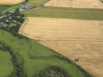 Oblique aerial view of the excavation trench with Forteviot village beyond, taken from the WSW.