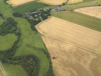 Oblique aerial view of the excavation trench with Forteviot village beyond, taken from the SW.