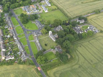 Oblique aerial view of Dalmeny centred on St Cuthbert's Church, taken from the ESE.