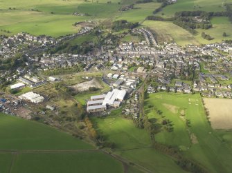 General oblique aerial view centred on the newly constructed Biggar High School, taken from the S.