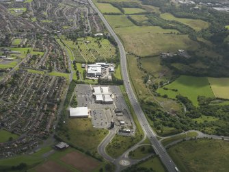 General oblique aerial view of the Showcase Cinema, Coatbridge, with Old Monkland church and cemetery beyond, taken from the WNW.