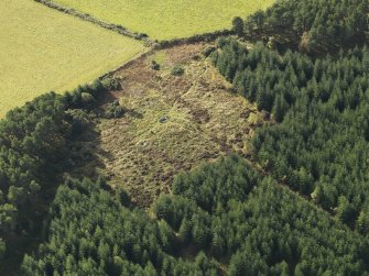 Oblique aerial view of the remains of Clune Wood Recumbent Stone Circle, taken from the NNE.