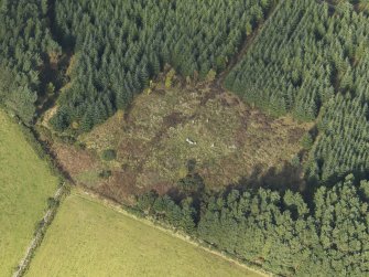 Oblique aerial view of the remains of Clune Wood Recumbent Stone Circle, taken from the SE.