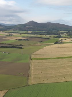 General oblique aerial view looking across the remains of Balquhain Recumbent Stone Circle with Mither Tap of Bennachie in the distance, taken from the ENE.