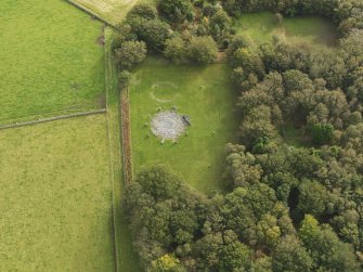 Oblique aerial view of the remains of the recumbent stone circle and enclosed cremation cemetery at Loanhead of Daviot, taken from the NW.