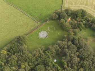 Oblique aerial view of the remains of the recumbent stone circle and enclosed cremation cemetery at Loanhead of Daviot, taken from the W.