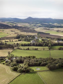 General oblique aerial view of the remains of the recumbent stone circle and enclosed cremation cemetery at Loanhead of Daviot with Mither Tap of Bennachie in the distance, taken from the NE.