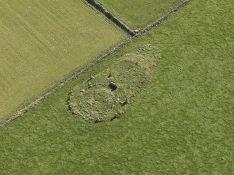Oblique aerial view of the remains of the recumbent stone circle at Aquhorthies, taken from the NW.