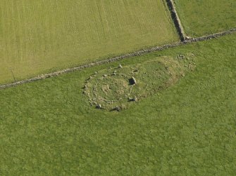 Oblique aerial view of the remains of the recumbent stone circle at Aquhorthies, taken from the WNW.