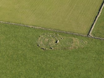 Oblique aerial view of the remains of the recumbent stone circle at Aquhorthies, taken from the WSW.