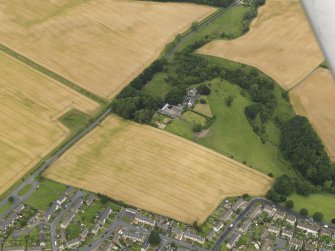 Oblique aerial view of the cropmarks of the field boundary and Burnhead Tower, taken from the SSW.