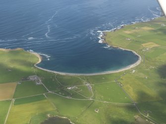 General oblique view of the Bay of Skaill with Skara Brae to the right and Skaill House adjacent, taken from the SE.