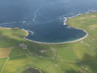 General oblique view of the Bay of Skaill with Skara Brae to the right and Skaill House adjacent, taken from the SE.