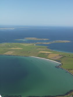Oblique aerial view across the Bay of Holland, Stronsay with Papa Stronsay beyond, taken from the SW.