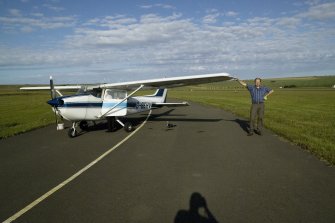 Kevin Macleod (RCAHMS Aerial Survey Mapping Manager) on the apron at Kirkwall during RCAHMS aerial survey.