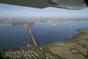 General oblique aerial view of the Forth Rail Bridge with the Queen Mary 2 in the back ground, taken from the S.