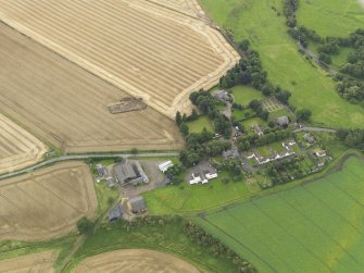 Oblique aerial view of Forteviot village and the square barrow under excavation in 2009, taken from the NNE.