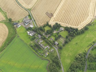Oblique aerial view of Forteviot village and the square barrow under excavation in 2009, taken from the NW.