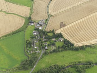 Oblique aerial view of Forteviot village and the square barrow under excavation in 2009, taken from the WSW.