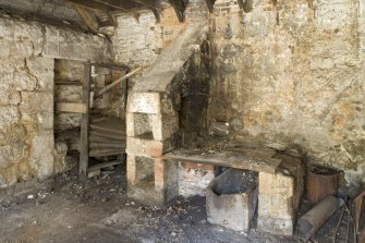 Interior. Smiddy, view of bellows and remains of forge