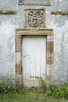 Detail of doorway with date lintel and heraldic panel above