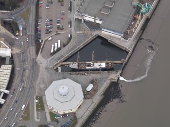 Oblique aerial view of the Old Dundee harbour centred on the Discovery, taken from the SW.