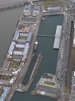 General oblique aerial view of the new development in Dundee harbour centred on the Victoria Docks, taken from the ENE.