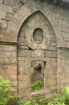 Detail of arch with doorway and blocked circular opening above