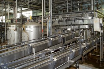 Bottling Plant. Interior. View  from south east of pasteuriser and conveyors. The pasteuriser sterilises the beer in the bottle.
