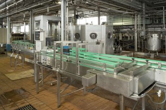 Bottling Plant. Interior. View  from south of Simon crowner (left) and  bottle filler (right) with conveyor taking the filled and crowned bottles to the pasteuriser.
