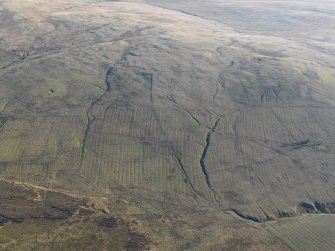 General oblique aerial view of the remains of the enclosure, field boundaries, rig and trackways, taken from the NNW.