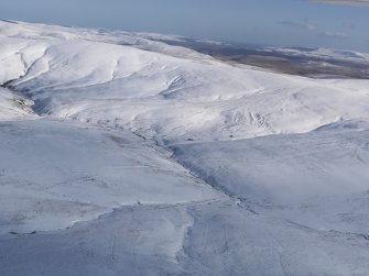 General oblique aerial view of Chew Green Roman fortlet and temporary camps, a scooped settlement and sheepfold in snow, looking E.