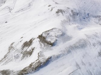 Oblique aerial view of palisaded settlement, rig and furrow, cord rig and cultivation terraces under snow, looking to W.