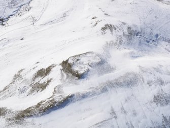 Oblique aerial view of palisaded settlement, scooped settlement, rig and furrow, cord rig and cultivation terraces under snow, looking to W.