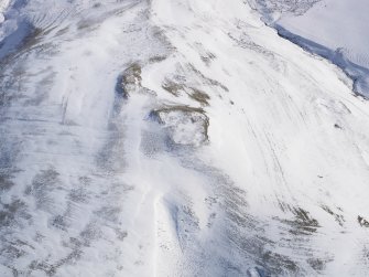 Oblique aerial view of palisaded settlement, scooped settlement, rig and furrow, cord rig and cultivation terraces under snow, looking to SE.