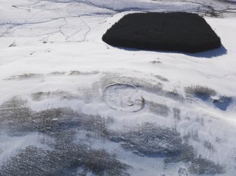 Oblique aerial view of settlement and cord rig under snow, looking to WSW.