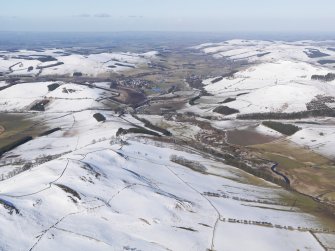 General oblique aerial view along the Bowmont Water towards Town Yethom and Kirk Yetholm, looking to the NNE.