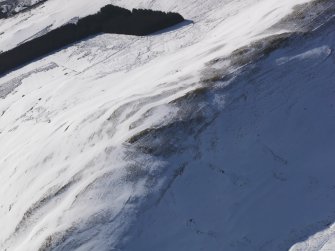 Oblique aerial view of palisaded settlement under snow, looking to WSW.