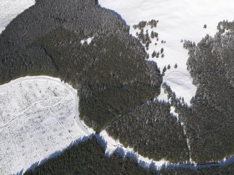 Oblique aerial view of scooped settlement and settlement under snow, looking to NE.