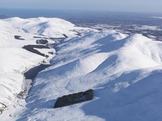 General oblique aerial view of Pentland Hills and Loganlee Reservoir under snow, looking ENE.